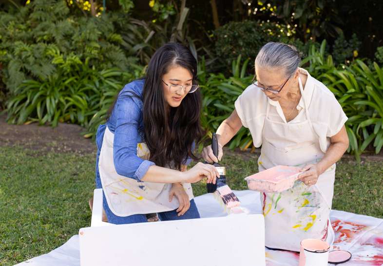 grandmother and daughter painting together